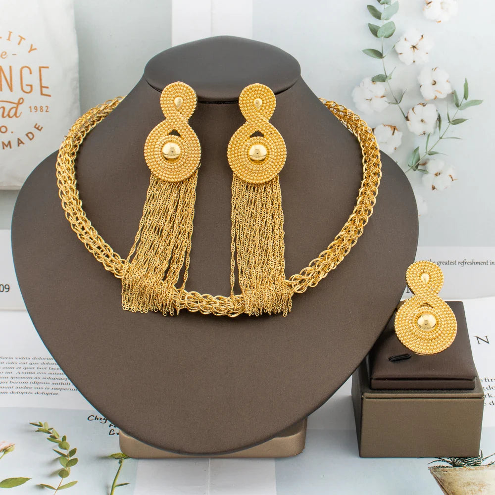 Exquisite 3-piece African fashion jewelry set featuring luxurious gold tassel earrings, elegantly crafted necklace, and stylish ring for women, ideal for special occasions.