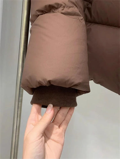 Textured cotton padded jacket for women, hooded with refined detailing, embodying sophistication in winter fashion.