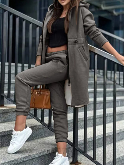 Fashionable women's hooded tracksuit paired with ankle-length pants, perfect for autumn and winter seasons.