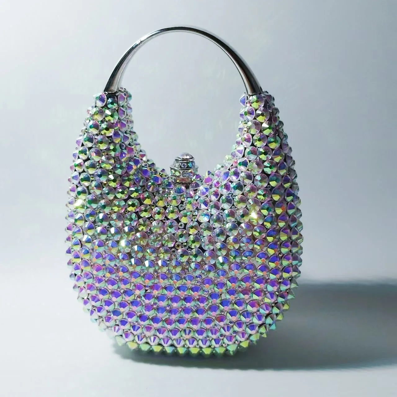 Elegant women's minaudiere evening clutch bag featuring a luxurious metallic finish adorned with sparkling crystal diamonds, perfect for sophisticated occasions.