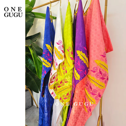 Stylish African bazin dress in stunning royal blue, ideal for formal events and cultural celebrations featuring vibrant embroidery and stone embellishments.