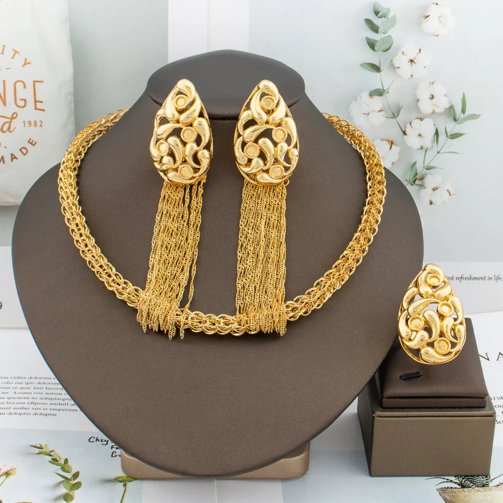 Complete luxury 3-piece African fashion jewelry set for women, featuring gold tassel earrings, a statement necklace, and a stylish ring.