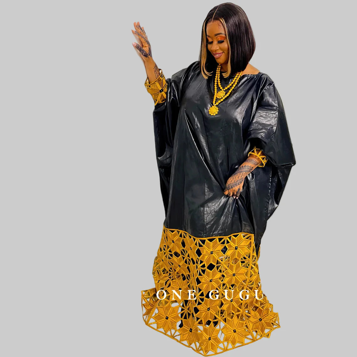 Elegant African Bazin gown in rich gold with intricate embroidery, showcasing a plus size long sleeve dashiki design.