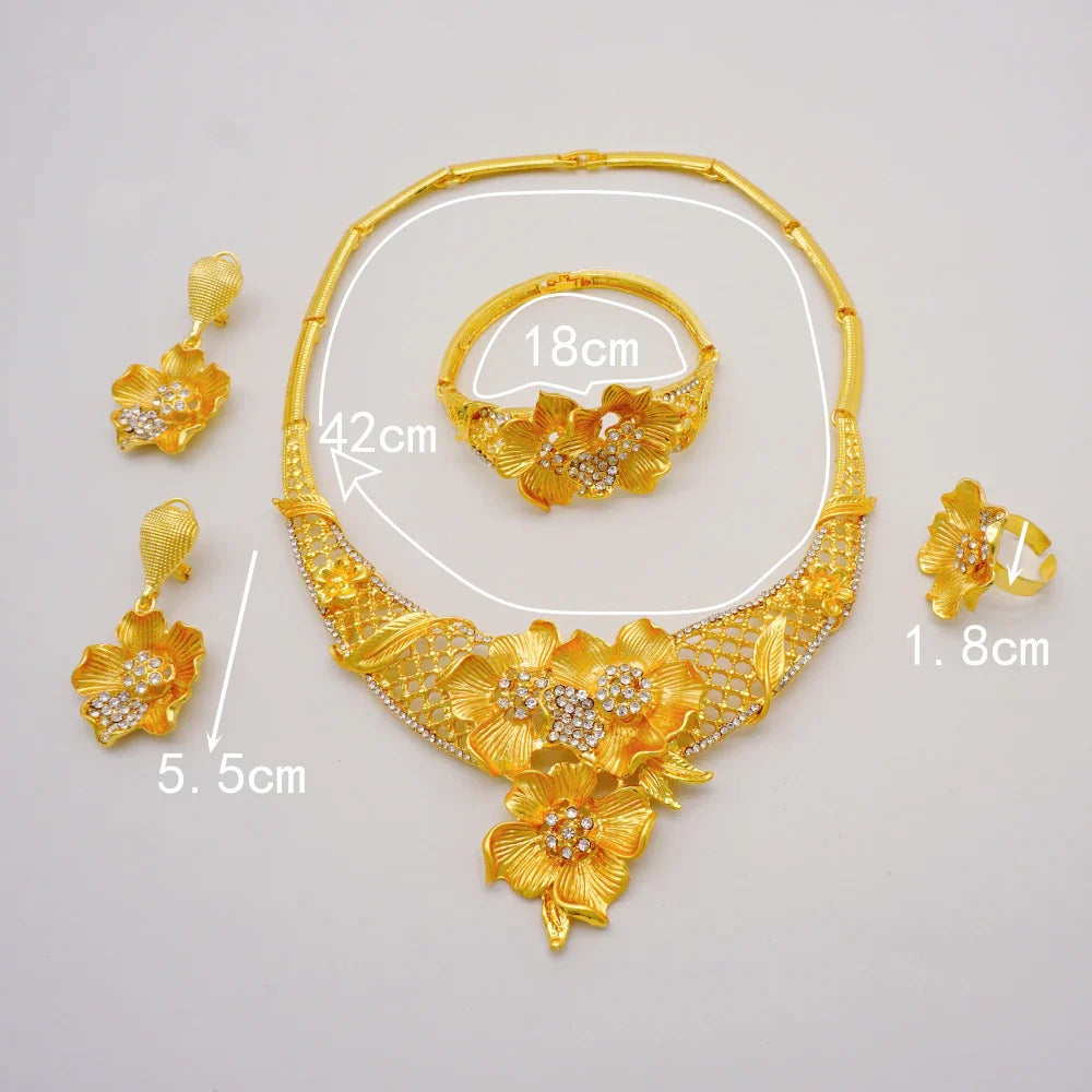 Beautifully arranged luxury gold colour jewelry set, ideal for brides, featuring distinct African style and intricate details in necklace, earrings, bracelet, and ring.
