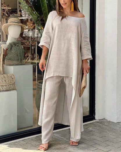 Sleek and sophisticated women's casual outfit, combining a fashionable asymmetrical top with stylish ankle-length wide leg pants.