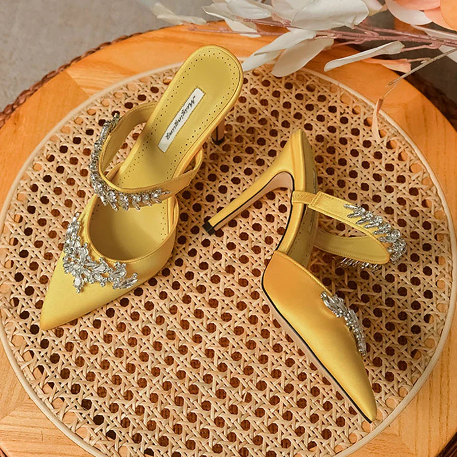 Sophisticated summer mules featuring a low heel, crafted from silk with sparkling rhinestones for a luxurious touch.