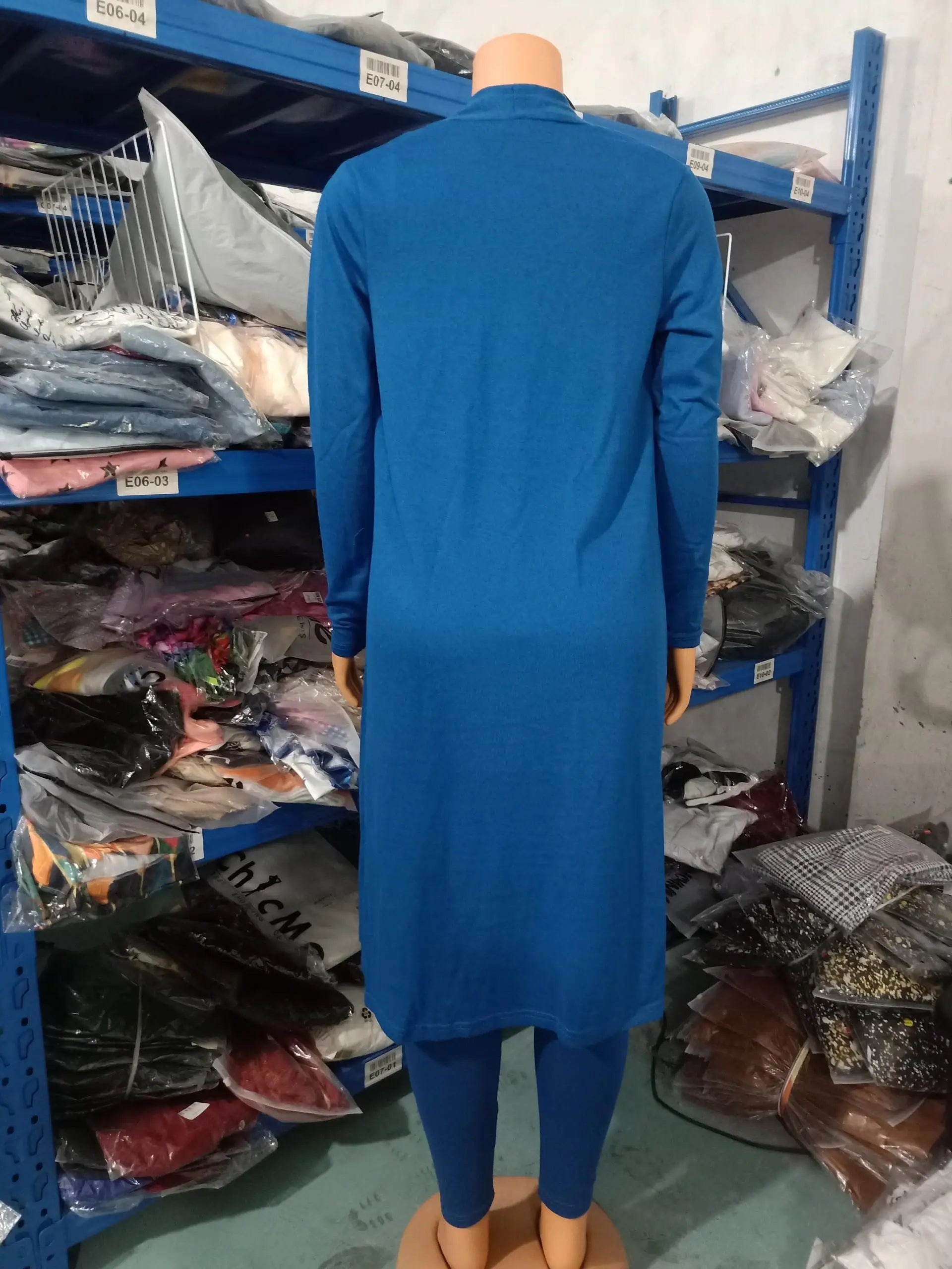 Stylish sleeveless women's jumpsuit paired with a long sleeve coat, crafted from premium polyester for a luxurious look and comfort.