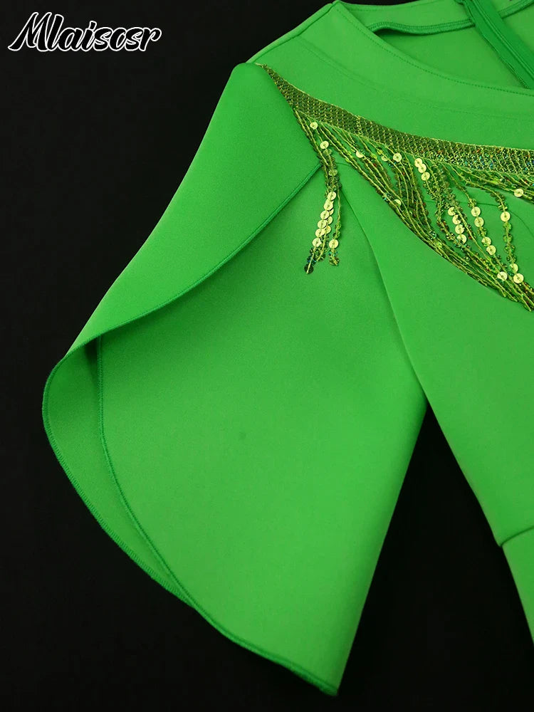 Chic model wearing the green sequin tassel dress by Mlaiscsr, highlighting the flattering empire waistline and sophisticated aesthetic.