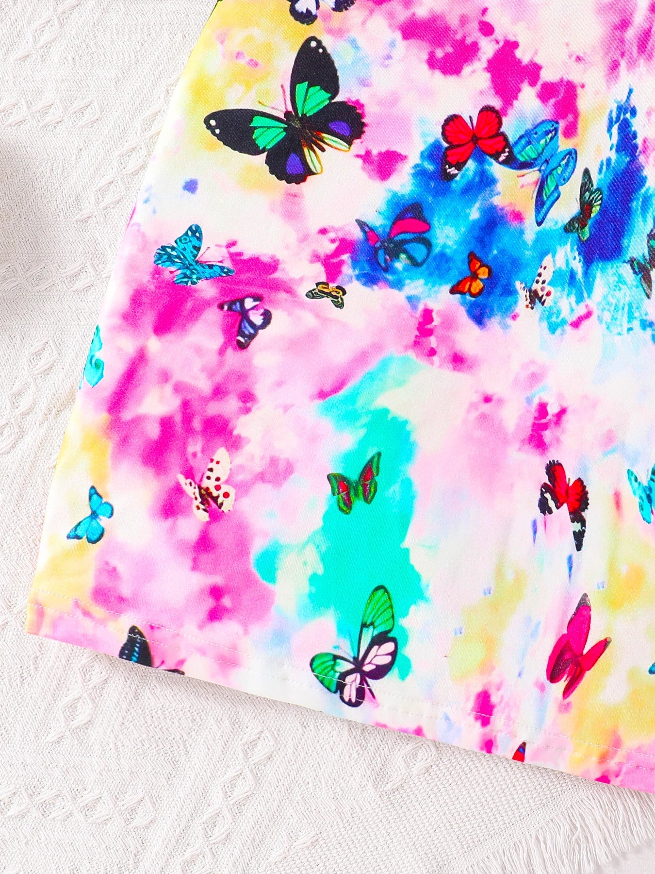 Luxury girls' autumn fashion 2-piece set featuring a solid colour round neck top paired with a charming butterfly pattern suspender skirt, designed for ages 7 to 13.