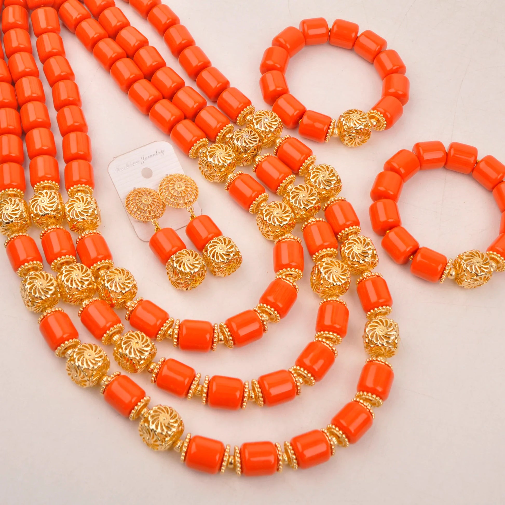 Complete bridal jewelry set with matching earrings and bracelet, crafted from beautiful artificial coral beads, epitomising luxury and style for a Nigerian wedding.