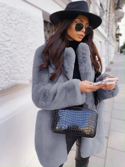 Fashion-forward women's faux fur coat with stylish pockets, representing modern luxury winter wear.