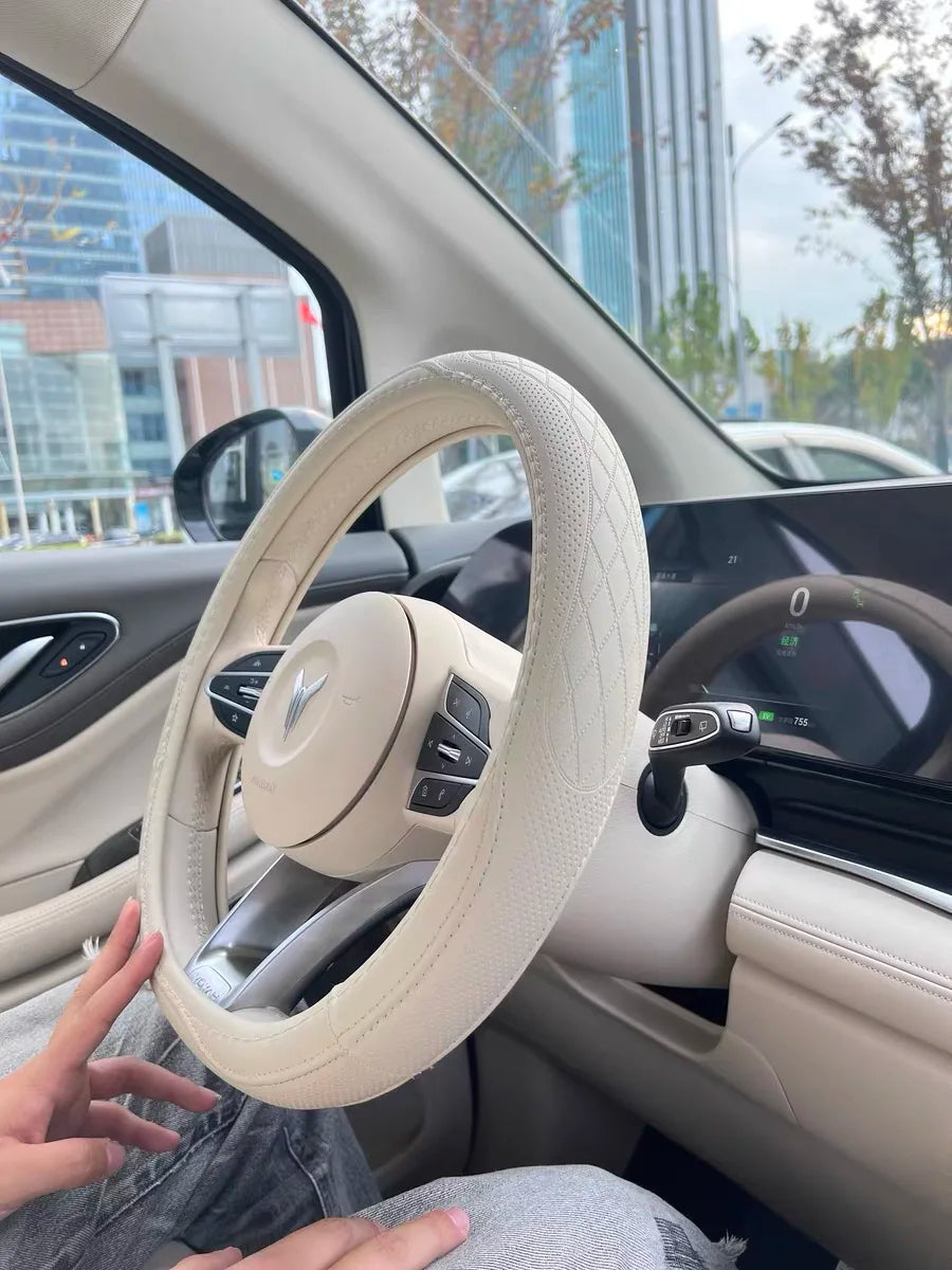 Stylish Napa Leather Steering Wheel Cover adorned with intricate patchwork details, blending luxury and functionality for auto enthusiasts.