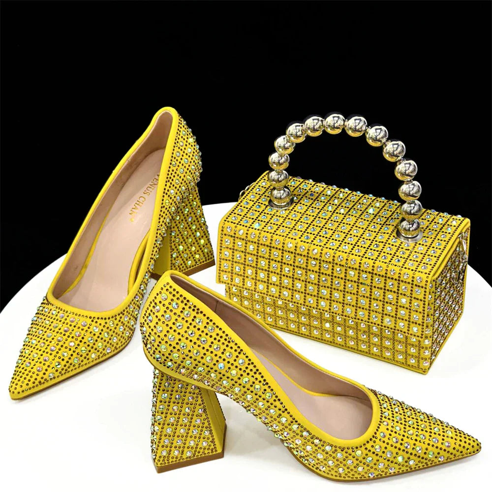 Elegant matching bag set with a metal handle, designed to complement luxury women's yellow rhinestone pointed toe slingback pumps for a glamorous look.