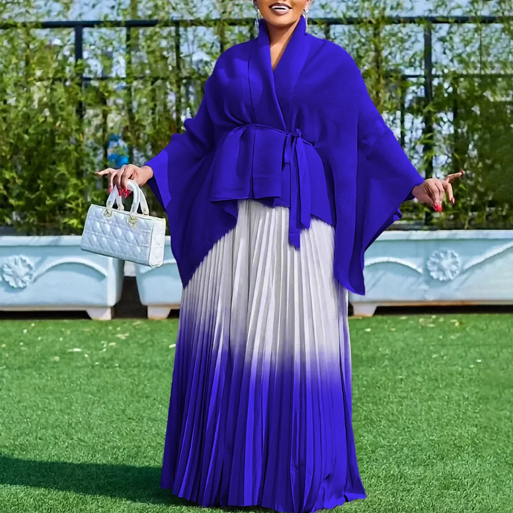 Stylish model showcasing the Luxury Dashiki two-piece women's outfit, featuring rich purple and blue hues, designed to embody elegance at cultural festivities.