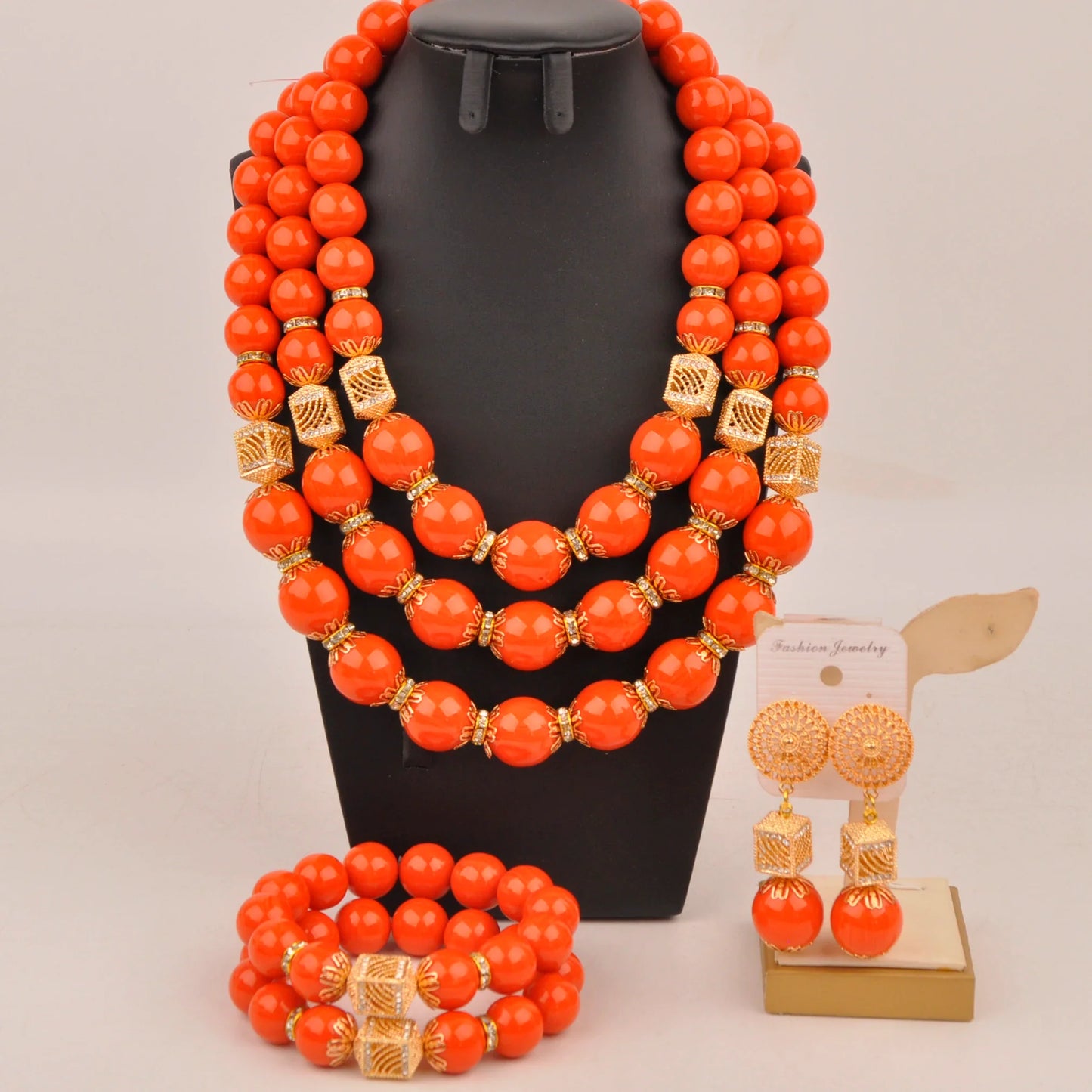 Complete Nigerian bridal jewelry set displayed elegantly with necklace, bracelet, and earrings, perfect for brides seeking fashion-forward luxury.