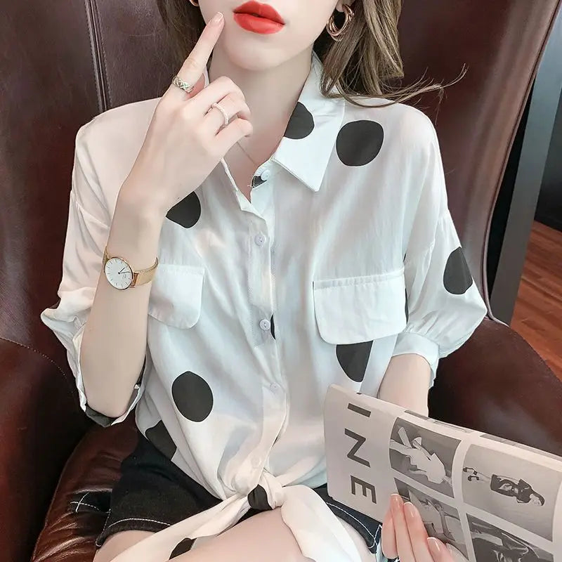 Stylist women's fashion polka dot blouse showcasing a charming bandage bow detail, suitable for both casual and elegant occasions.