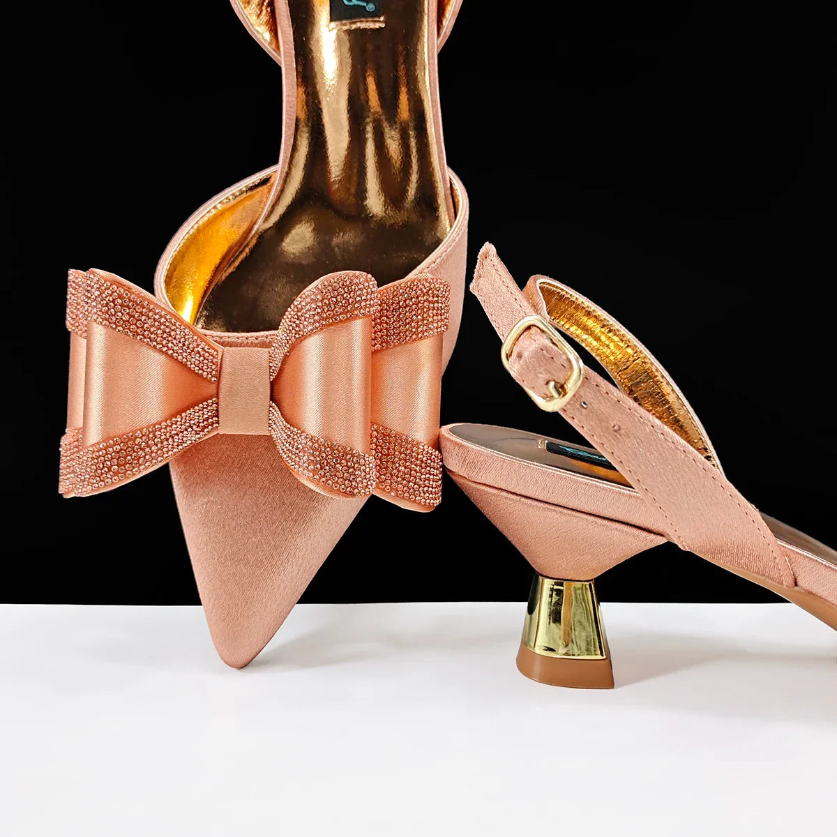 View of luxurious women's high-heeled shoes with a sleek silhouette, adorned with sparkling rhinestones, ideal for enhancing any party or wedding outfit.