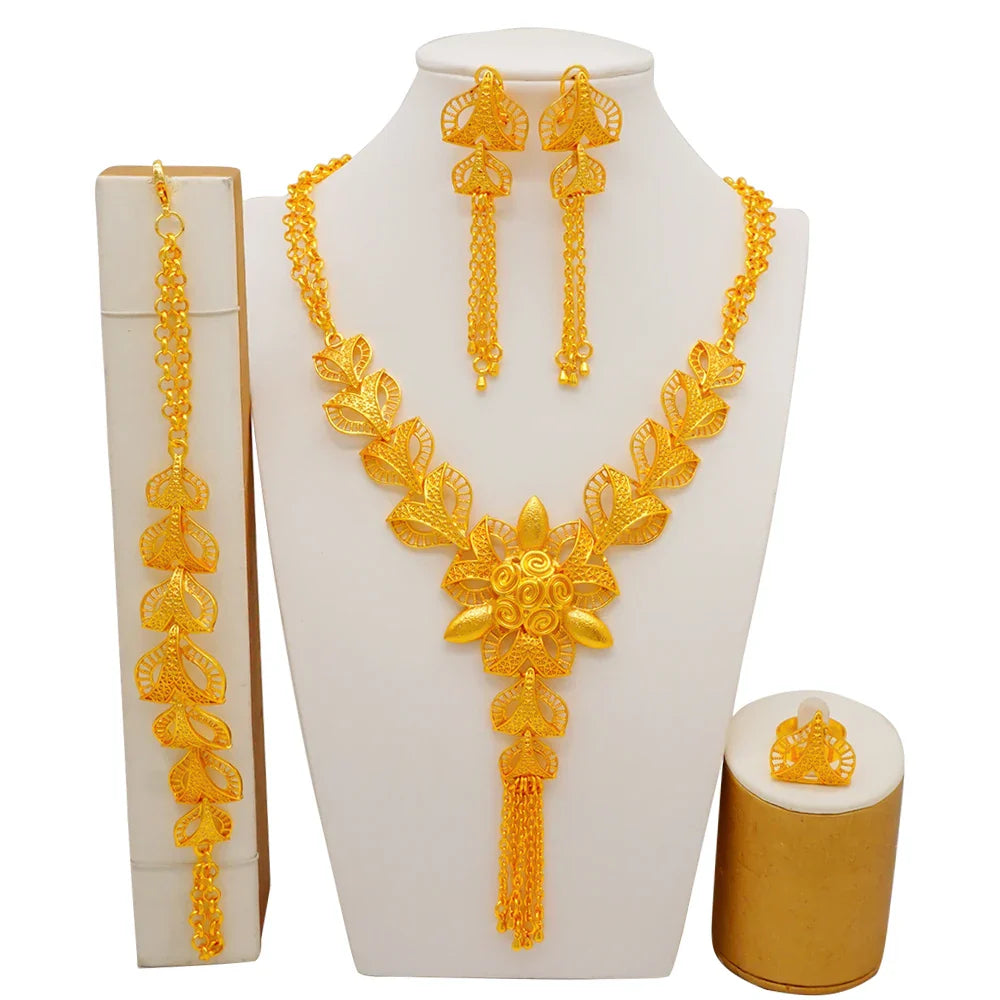 Stunning four-piece bridal jewelry set including a bracelet, ring, necklace, and earrings made of gold-coloured metal, perfect for weddings and special events.