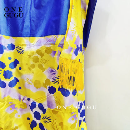 Close-up view of the detailed embroidery and lace decoration on the Luxury African Dashiki Wedding Dress in Blue Bazin Riche for women, highlighting exquisite craftsmanship.