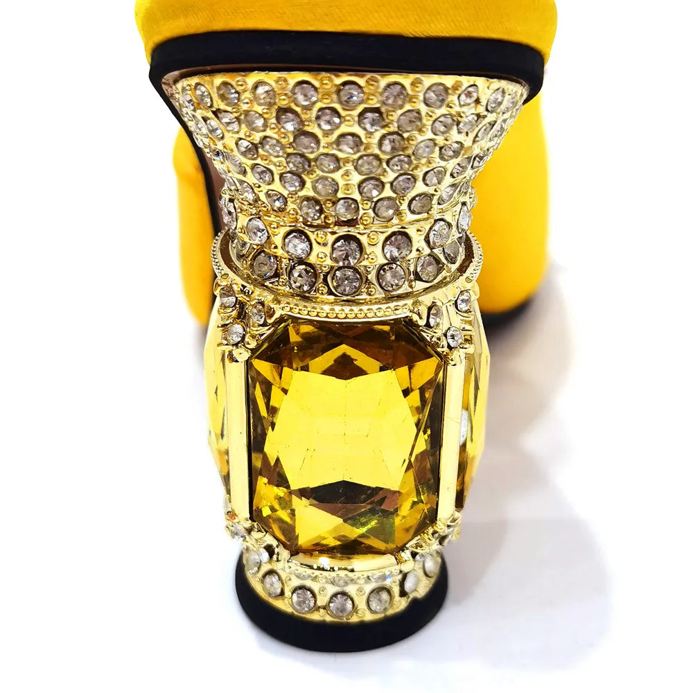 Luxurious yellow stiletto heels adorned with rhinestones, perfect for elegant parties and weddings.