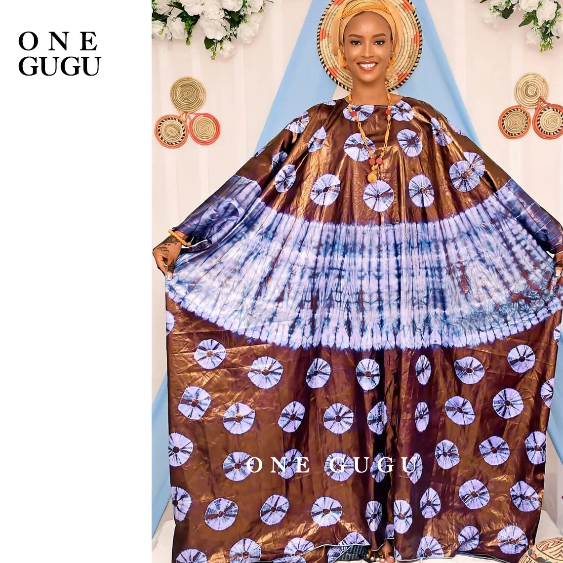 Sophisticated Bazin Riche dress featuring refined embroidery lace and a matching shawl, perfect for weddings and special events.