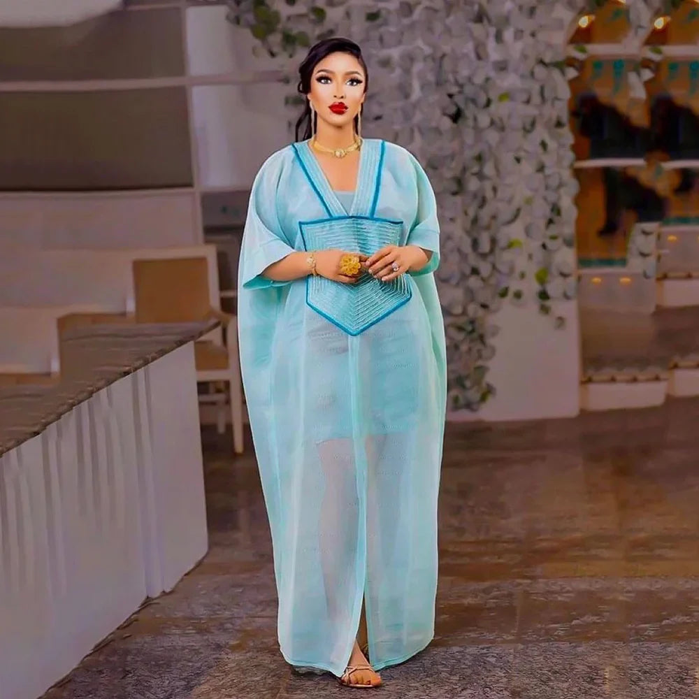 Elegant blue mesh embroidered dress designed for plus-size women, showcasing a contemporary African style.