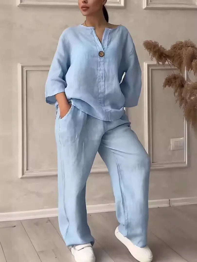 Stylish two-piece set combining a V-neck blouse and flowing wide leg pants, ideal for summer outings and casual gatherings.