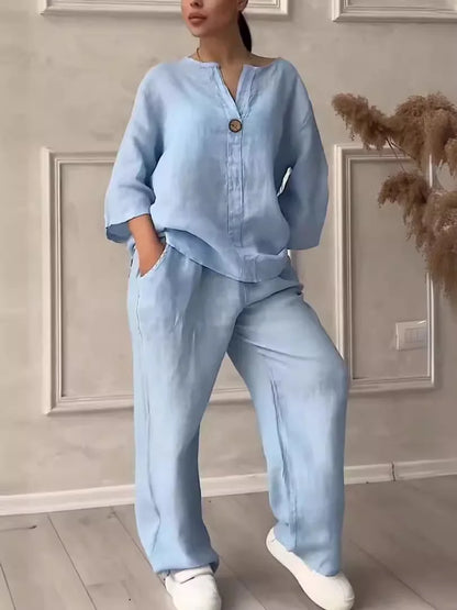 Stylish two-piece set combining a V-neck blouse and flowing wide leg pants, ideal for summer outings and casual gatherings.