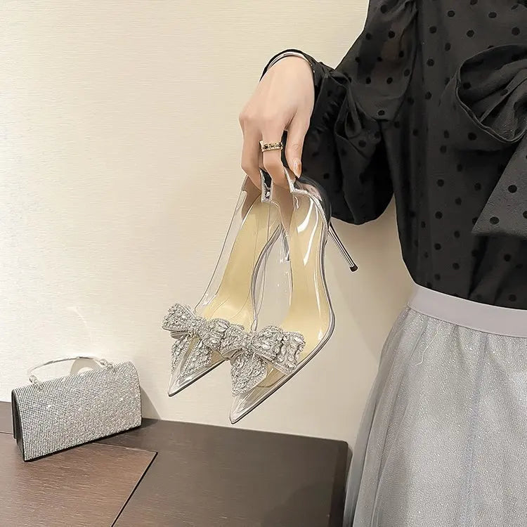 Elegant rhinestone bow transparent high heels sandals for women, showcasing modern fashion and formal wear allure.