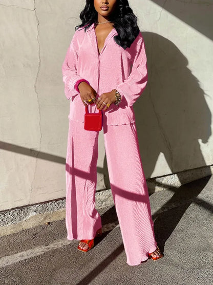 Stylish and trendy women's autumn/winter outfit set including a pleasing pleated shirt and chic high waist wide leg trousers.