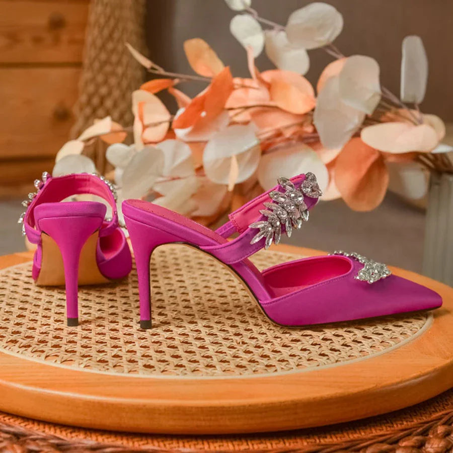 Close-up of luxurious silk upper featuring intricately placed rhinestones on women's pointed stiletto mules sandals.