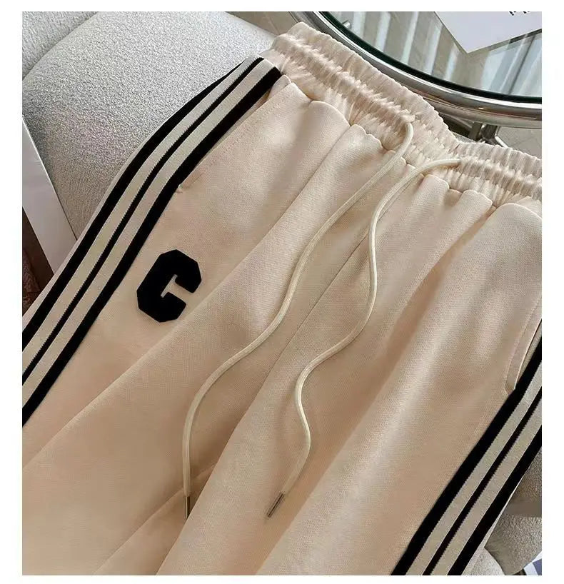 Stylish high-end women's leisure wear showing a chic two-piece outfit with wide leg trousers and a beautifully embroidered coat, perfect for autumn and winter.