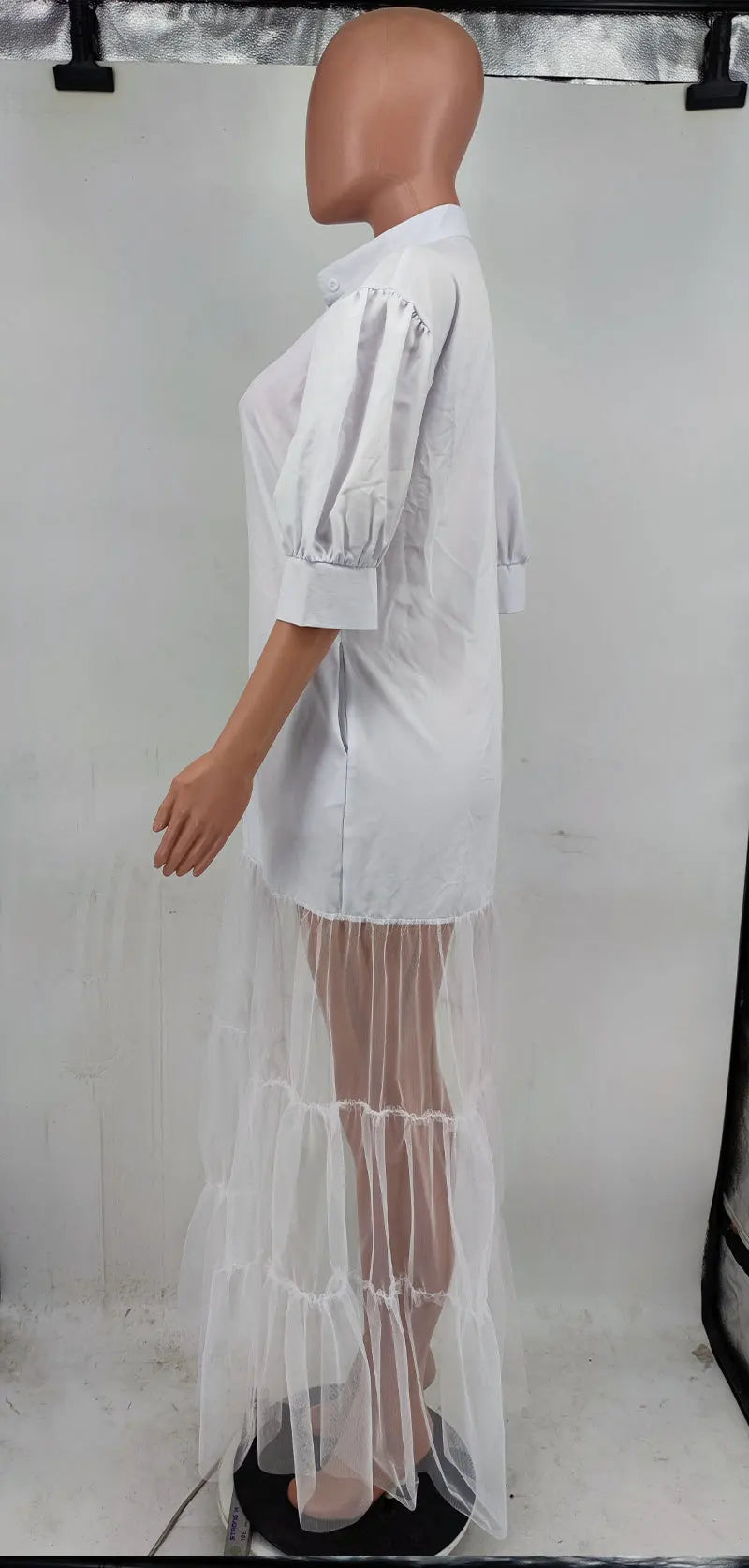Elegant turn-down collar on a white lace shirt dress, highlighting a blend of contemporary fashion and classic elegance.