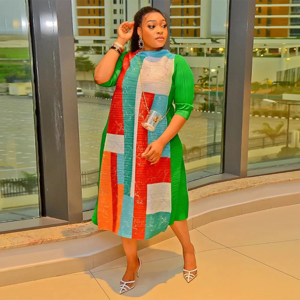 Model wearing the Elegant African Plus Size O-Neck Pleated Long Dress with 3/4 sleeves, highlighting its flattering silhouette and chic design for modern women.