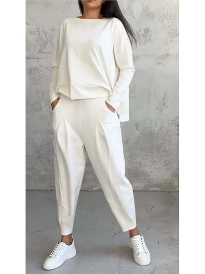 Complete look of the women’s casual sports set featuring elegant high waist harem pants and an irregular long sleeve top, ideal for modern, stylish women.