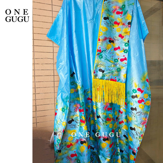 Close-up detail of embroidered lace and stones on a luxury blue Dashiki wedding dress, epitomising traditional African elegance.