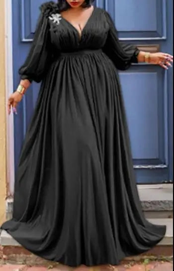 Model wearing an elegant Kanga style African maxi dress, featuring long sleeves and a vibrant print, ideal for an upscale wardrobe.