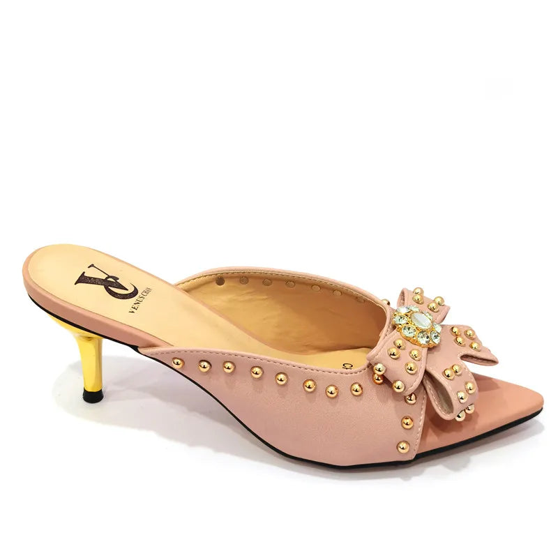 Chic matching bag set complementing sophisticated women's high heeled shoes with a pointed toe and super high heels.