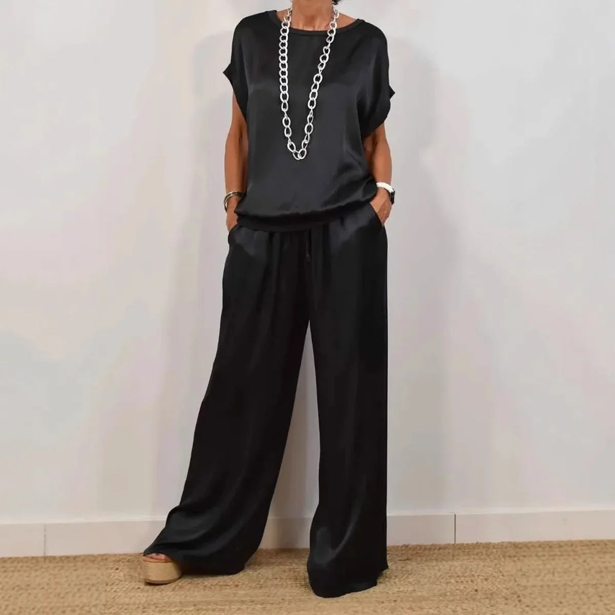 Fashionable women’s summer outfit featuring high-waisted wide leg pants and a luxurious O-neck T-shirt, embodying elegance and style.