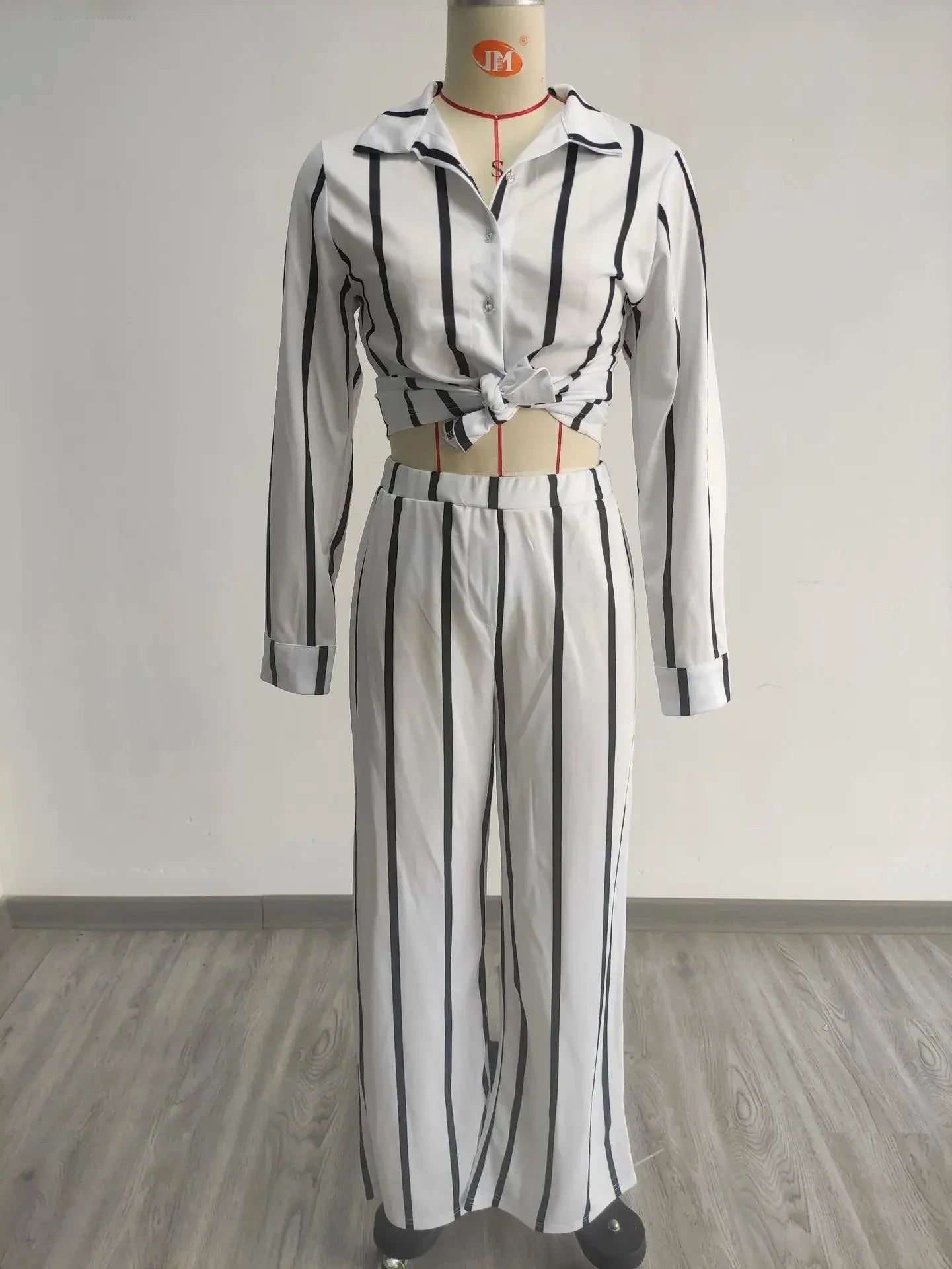 Complete look of the women's luxe casual two-piece striped set, ideal for fashionable leisure activities.