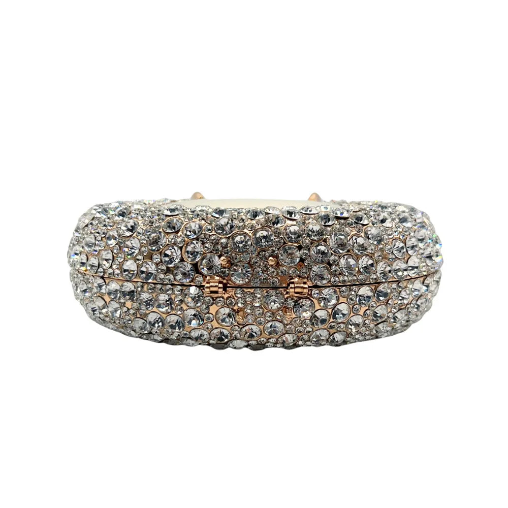 Stylish evening minaudiere featuring a hard metallic finish and crystal embellishments, ideal for special occasions.