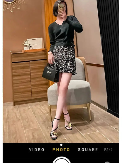 Glamorous black high heel sandals with an elegant gold metal flower strap, designed for women seeking opulence at events.