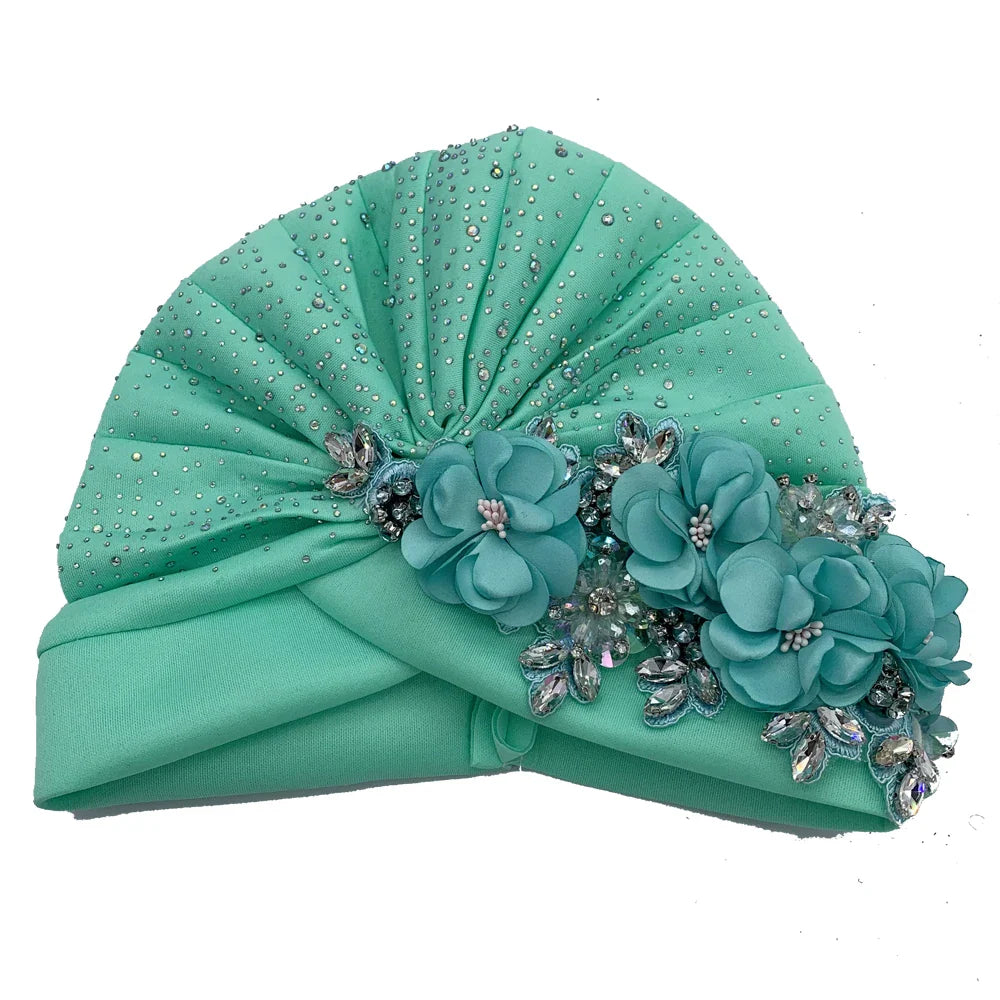Close-up of a sophisticated African turban cap showcasing intricate rhinestone decorations, crafted for women seeking elegance and comfort.