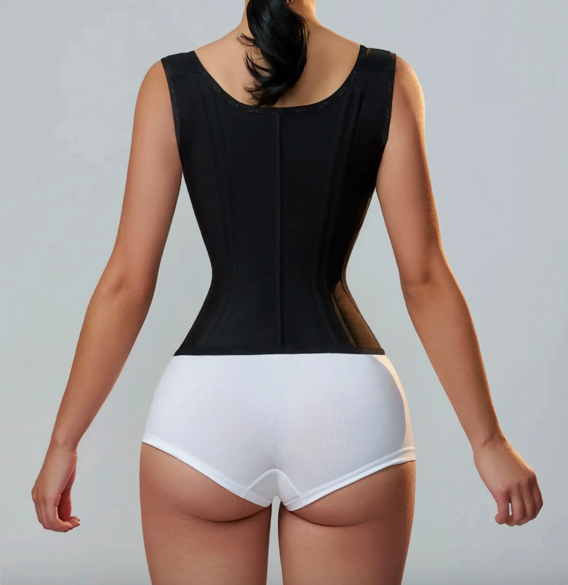 Sophisticated luxury latex waist cincher corset with a chic zipper and button closure, crafted for effective tummy control and a fashionable silhouette for discerning women.
