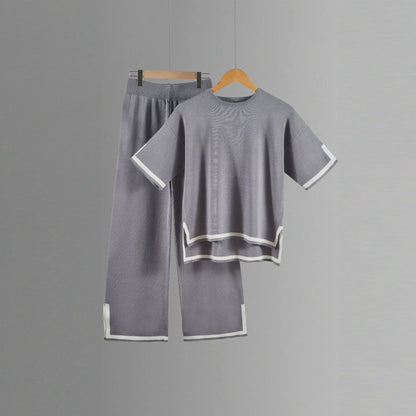 Chic ensemble showcasing loose-fit wide-leg trousers and a refined short-sleeved pullover, designed for an effortlessly elegant appearance.