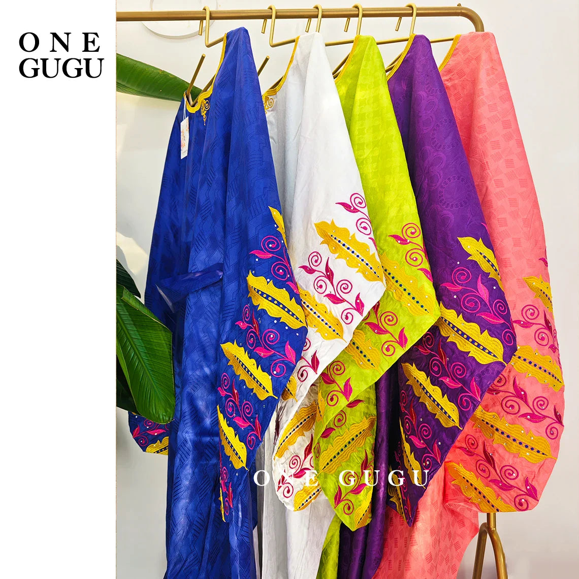 Woman elegantly dressed in a royal blue Boubou dress, showcasing the beauty of African fashion at a wedding, highlighted with decorative embroidery.