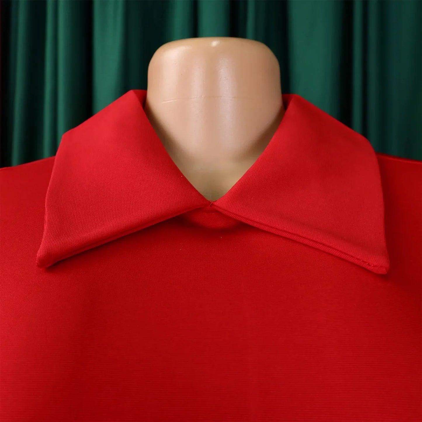 Model wearing a stunning high-waisted pleated dress, highlighting the stylish silhouette and sophisticated Peter Pan collar.