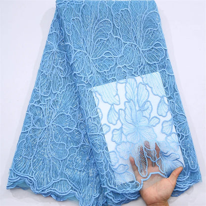 Premium quality Nigerian lace fabric embellished with sequins, perfect for creating luxurious wedding dresses and special occasion outfits.