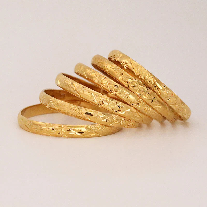 Stunning 8mm wide gold cuff bracelets, symbolising ethnic elegance, designed for fashionable individuals who appreciate luxurious accessories.