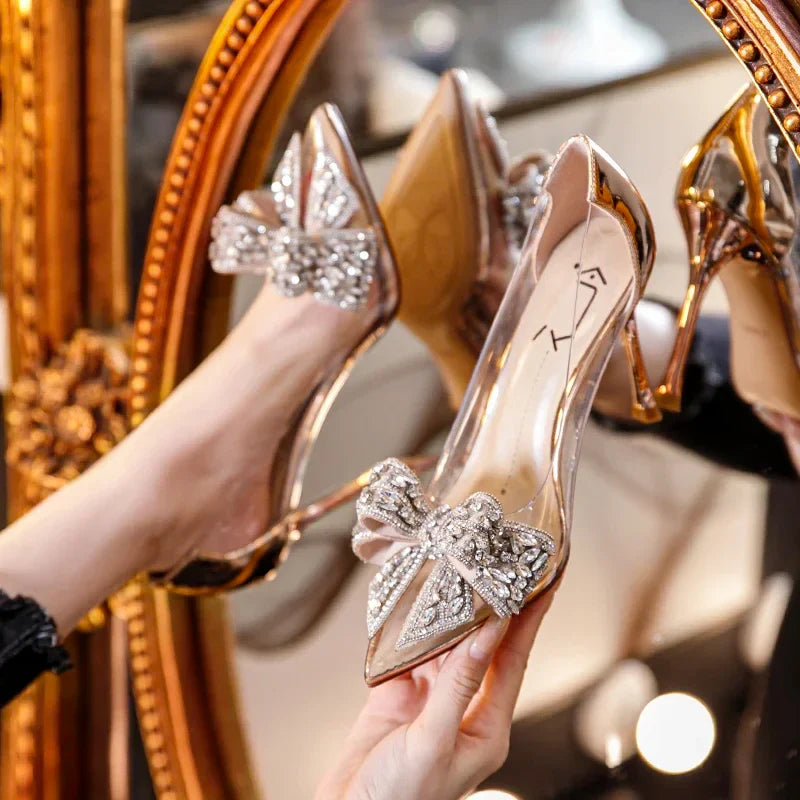 Fashion-forward women's transparent high heels with a brilliant diamond bow, designed for the discerning woman seeking sophistication and style.